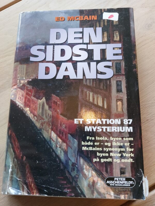 Forsiden af 'Den sidste dans' af Ed McBain, med et billede af bygninger i en by.