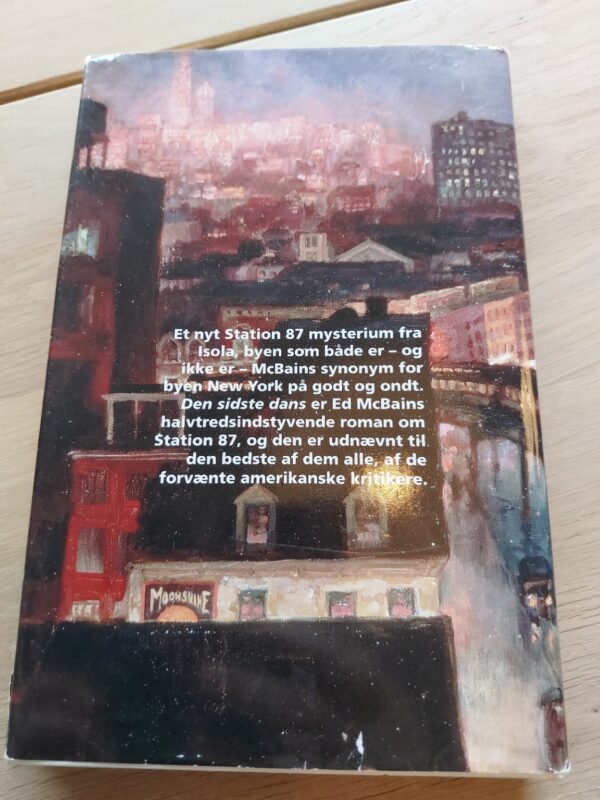 Bagsiden af 'Den sidste dans' af Ed McBain, med et billede af bygninger og bogbeskrivelse.