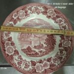Engelsk rød transferware tallerken, ca. 22 cm, med landskabs- og blomsterdesign. Med målebånd.