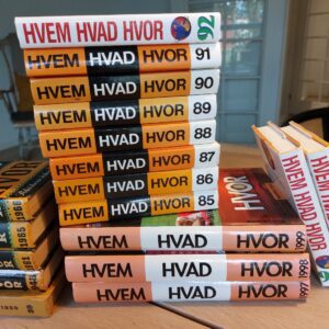 En gavekurv med udvalg af små mjødflasker. En trækasse mærket 'Glædelig Jul' vises med flasker såsom Valnød og Hindbær.