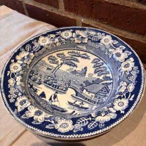 Blå og hvid porcelænsskål med landskabsmotiv og blomstermønster