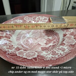 En 22 cm engelsk dyb tallerken i rød fajance med landskabsmotiv, et målebånd viser størrelsen.