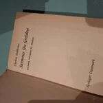 Indersiden af bogen 'Stemmer fra fortiden' af Evelyn Anthony, der viser titel, forfatter og forlag 'Forlaget Danmark'.