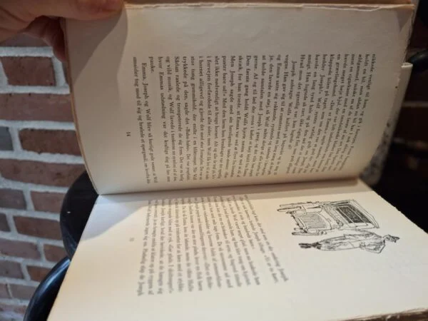 Åben bog 'Wolf med Paraplyen' med tekst og illustrationer, der viser en tegning af en bil og andre små illustrationer.
