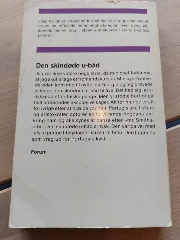 Hvid bagside til Den skindøde u-båd med tekst om en agent, dykning og en tysk ubåd ud for Portugal.