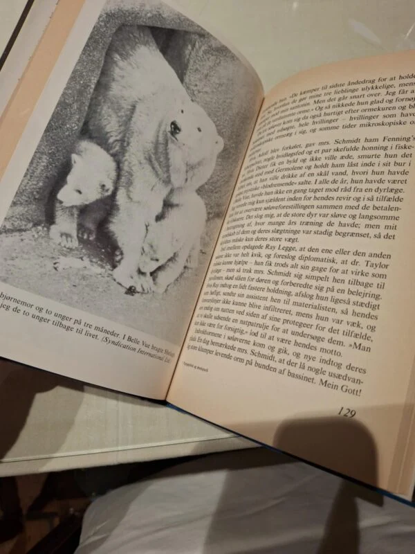 Opslået bog 'Papegøjebid og æselspark' med tekst og et sort/hvidt foto af en isbjørn med to unger.
