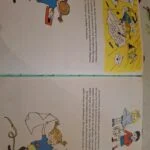 To opslåede sider fra en gammel Pippi Langstrømpe bog med farverige illustrationer af Pippi, Tommy og Annika.