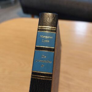 Ryggen af bogen 'De Forsvundne År' med sort og blå design