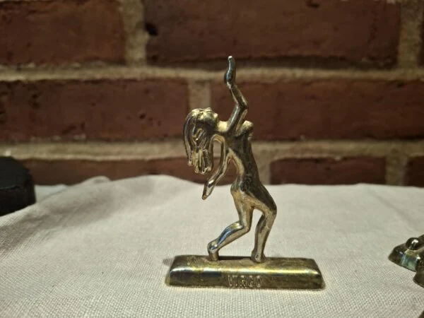 Messingfigur af jomfru på beige klæde