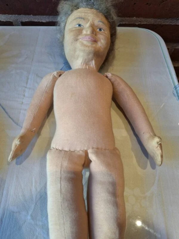 Nærbillede af marionetdukke iført ternet skjorte og blå bukser