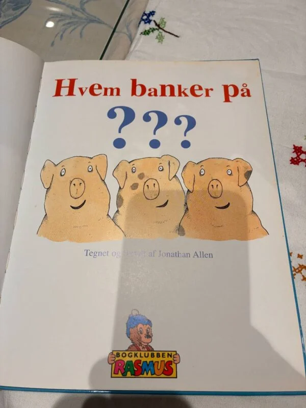 Indersiden af bogen 'Hvem banker på?' med titlen og illustrationer af grise