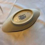 Bagsiden af det lille aflange fad med fodring og blåt Erik Sarreguemines-stempel.