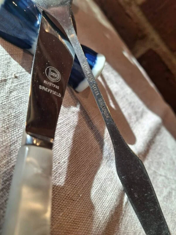 Nærbillede af kniv med perlemorsskaft og stålblad